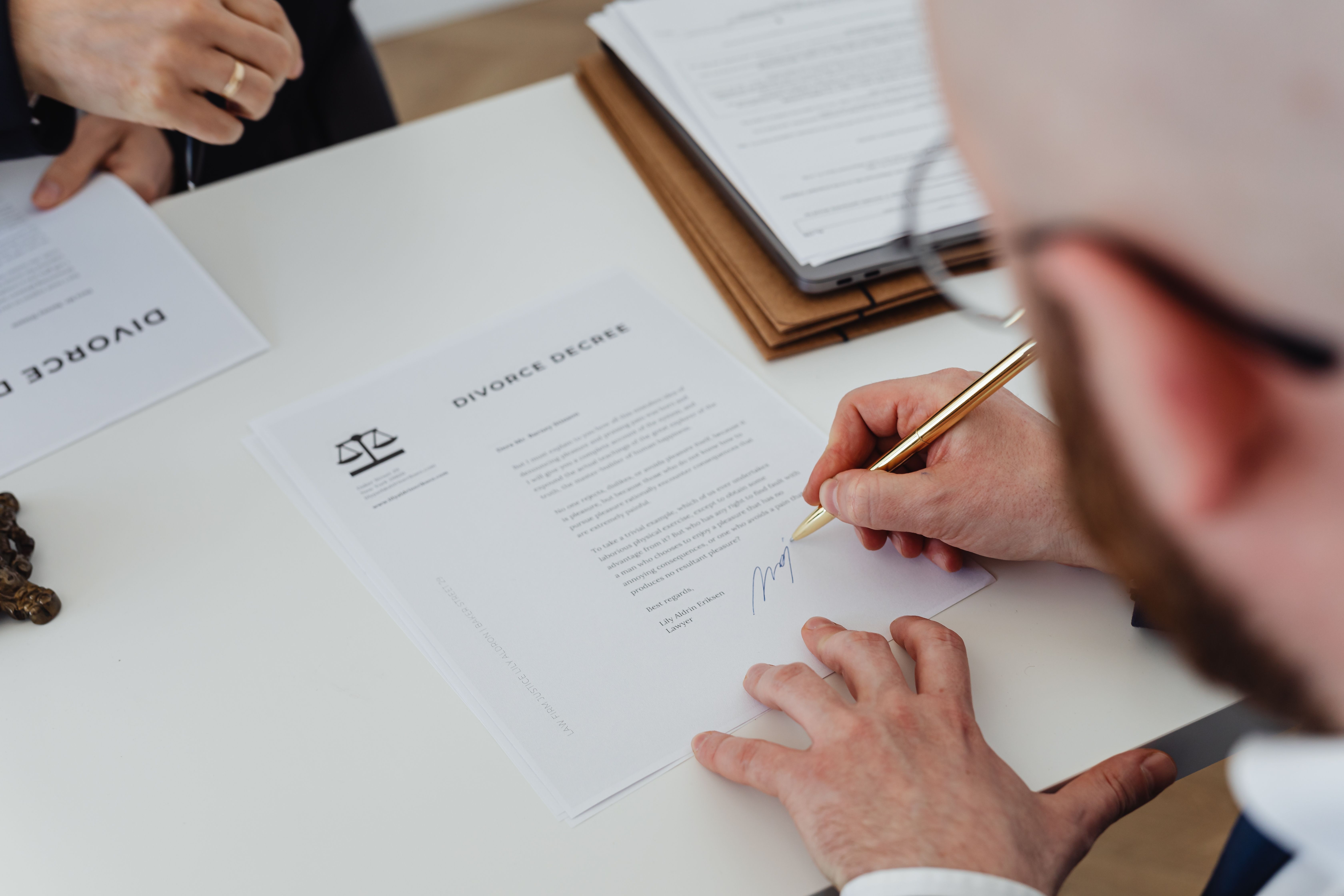 A lawyer reviewing signed case documents at a desk.